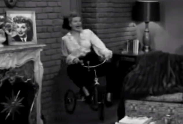 Poll: Which is creepier? The woman on the tricycle, or the photograph on the mantle?